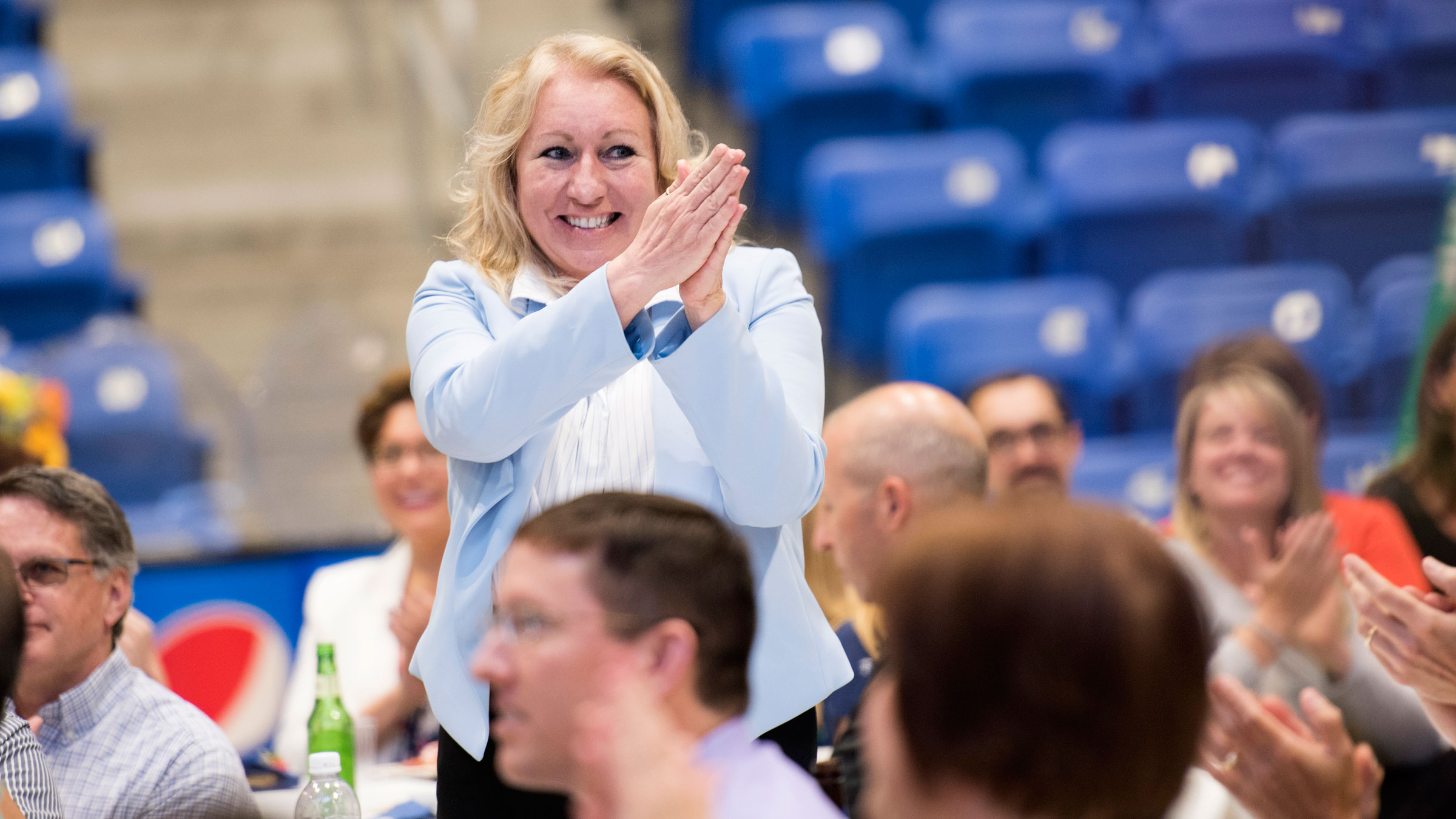 Janice Wachtarz smiles as the crowd around her claps during the Employee Recognition & Retiree Reception event.
